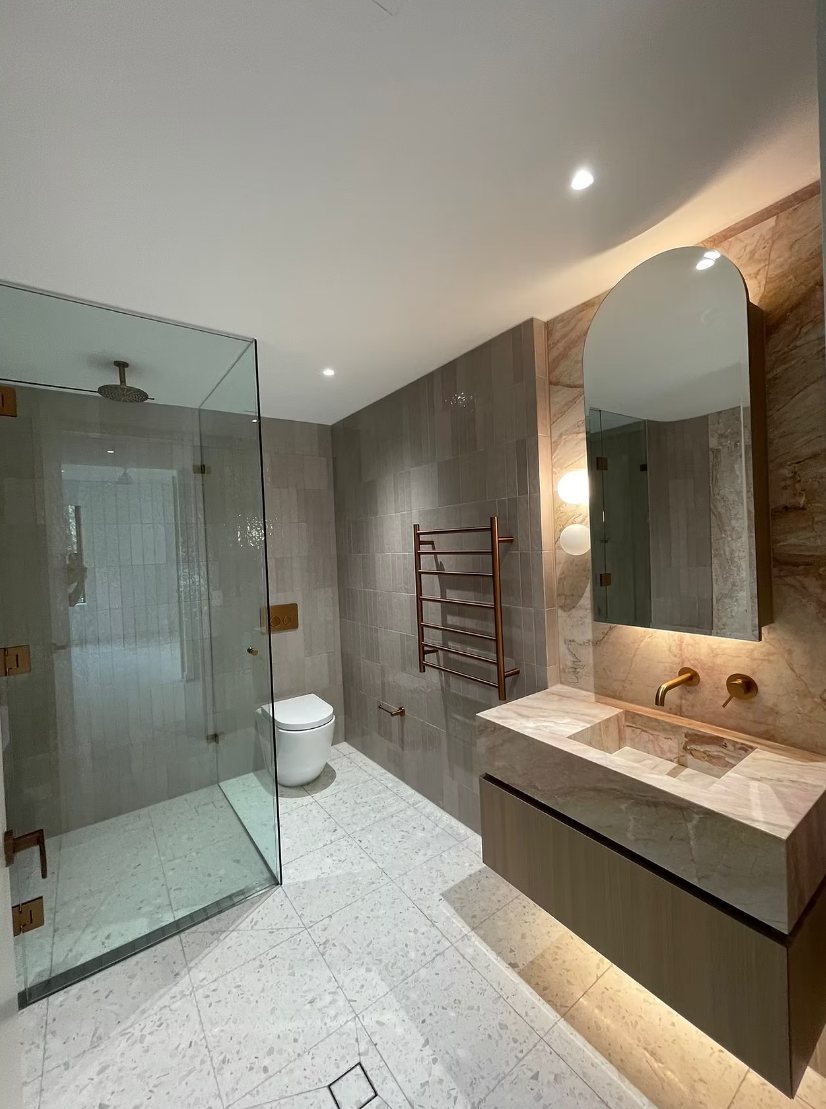 Bathroom with shower and tiling cleaned for handover in a new Bondi apartment