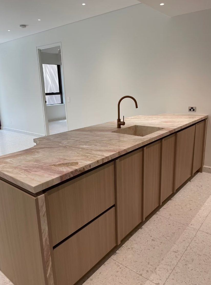 Kitchen island with stone benchtop after the Bondi apartments post-construction clean