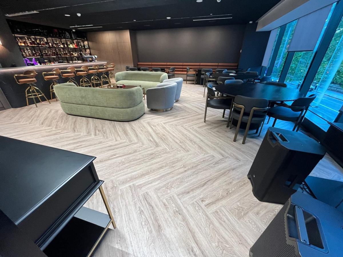 Clean office breakout space with timber floors and lounge seating