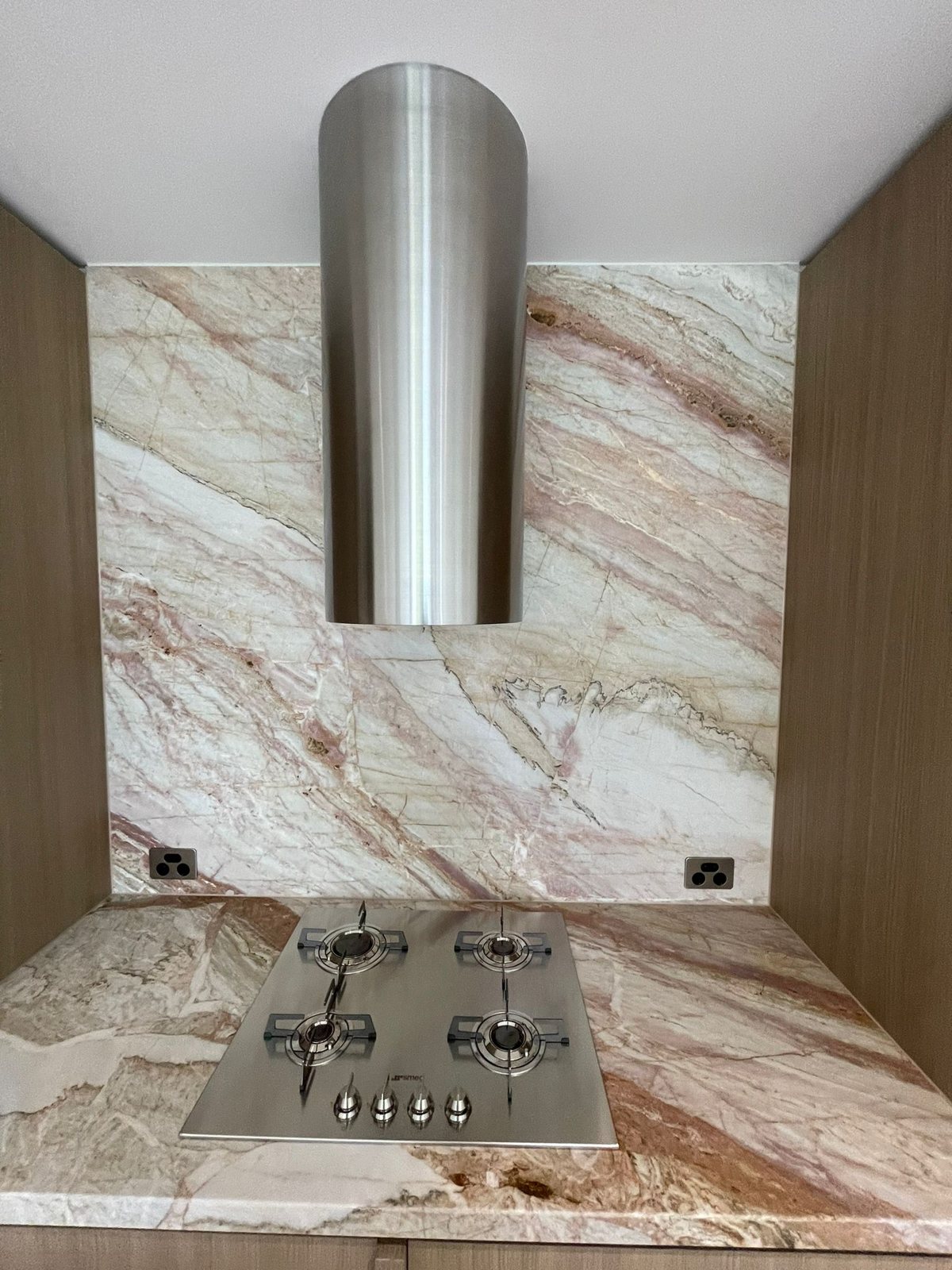 Stone splashback, benchtop and cooktop after a final clean