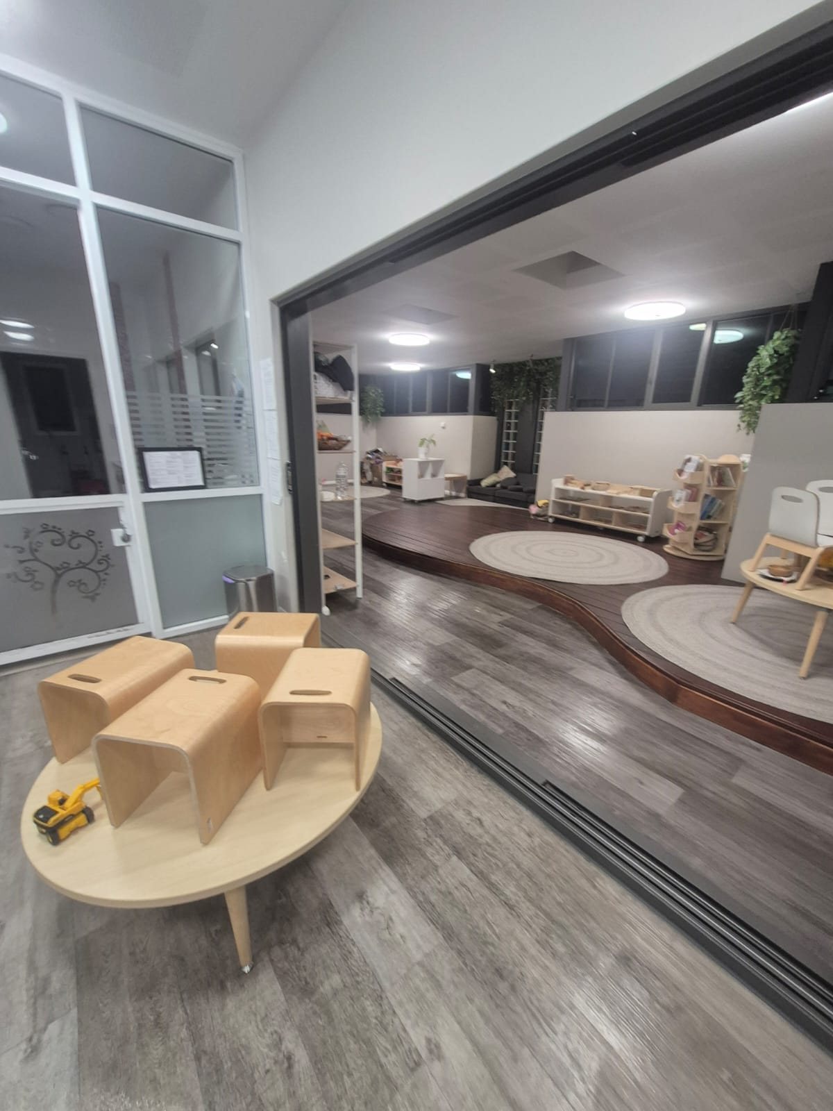 Play area with low tables and timber blocks after the evening clean