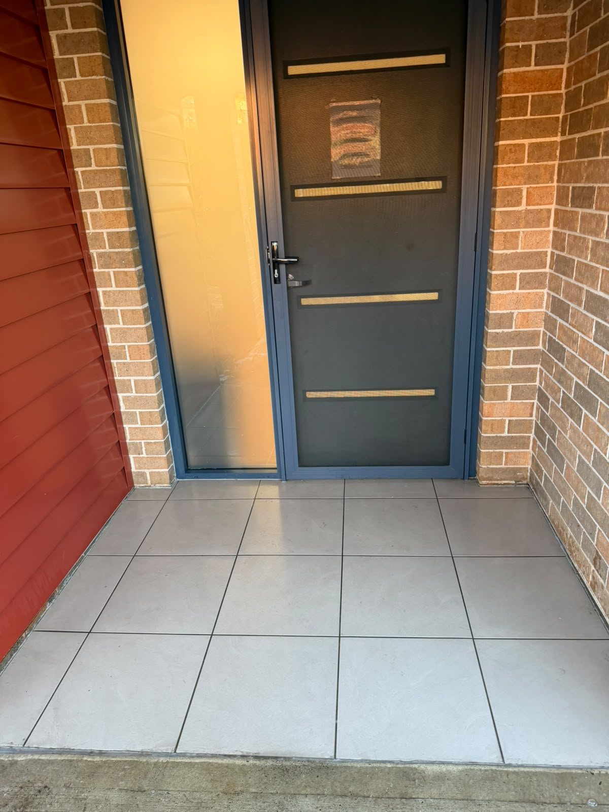 Tiled front entry of a townhouse complex after cleaning