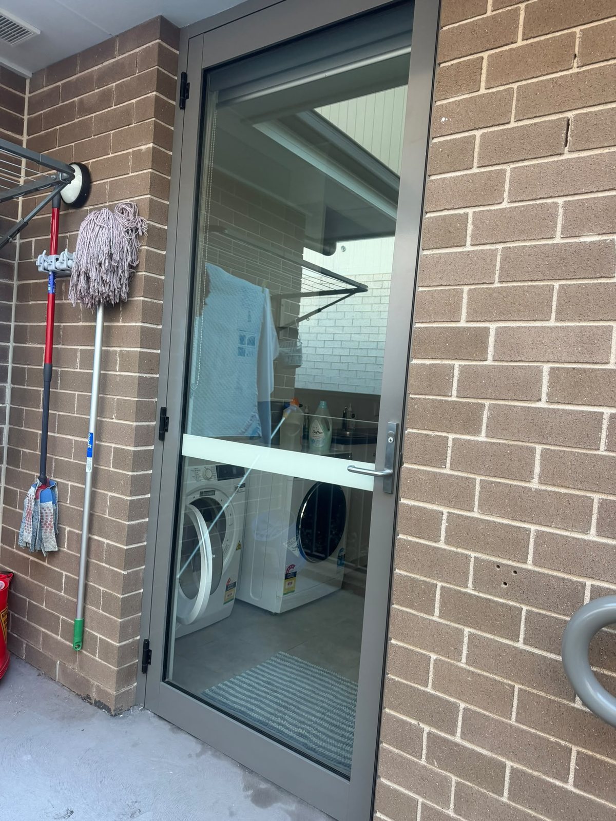 Rear entry and screen door of a townhouse complex after cleaning